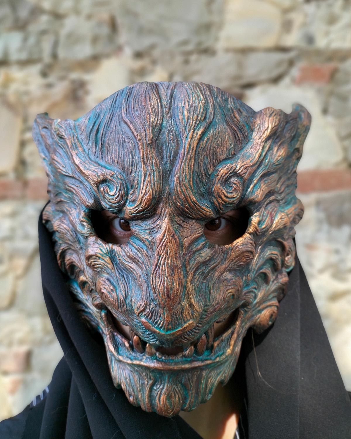 Front view without cap of handcrafted Oni mask with captivating oxidized colors